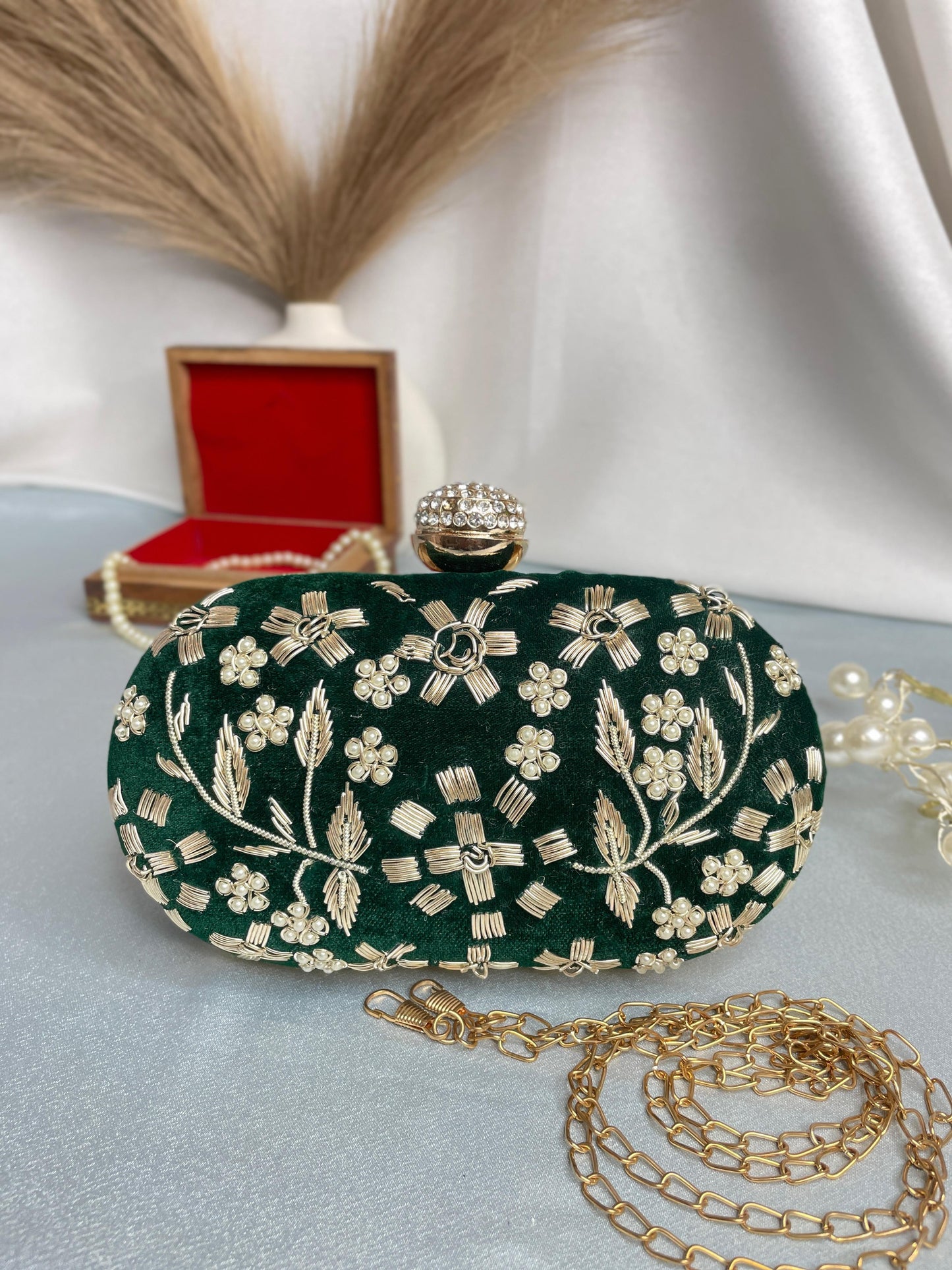 Hand embroidered capsule clutch