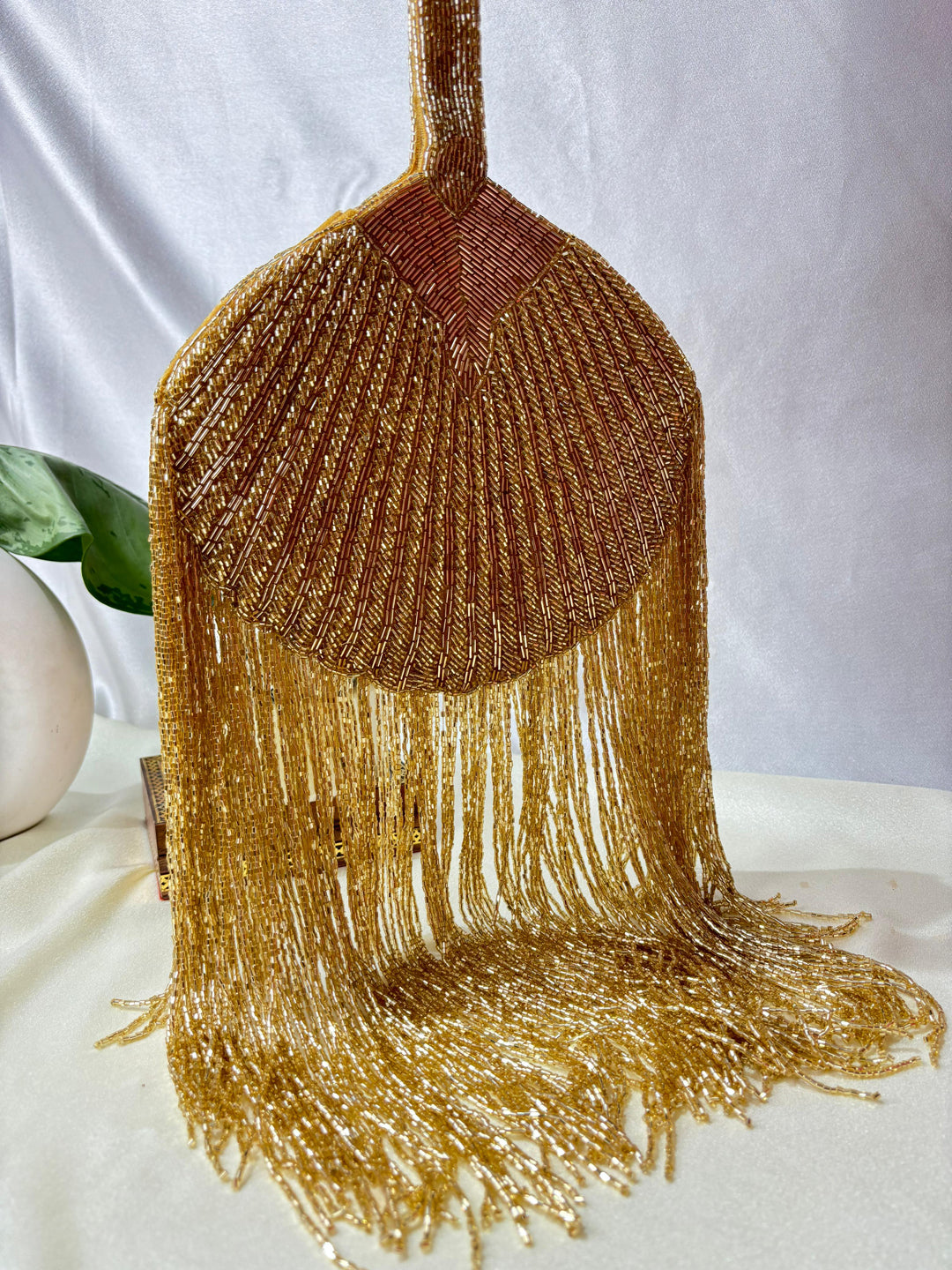 Gold Beaded Fringe Clutch with playful tassels and hidden button closure