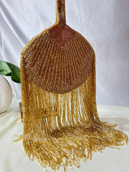 Gold Beaded Fringe Clutch with playful tassels and hidden button closure