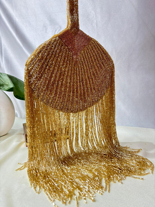 Gold Beaded Fringe Clutch with playful tassels and hidden button closure