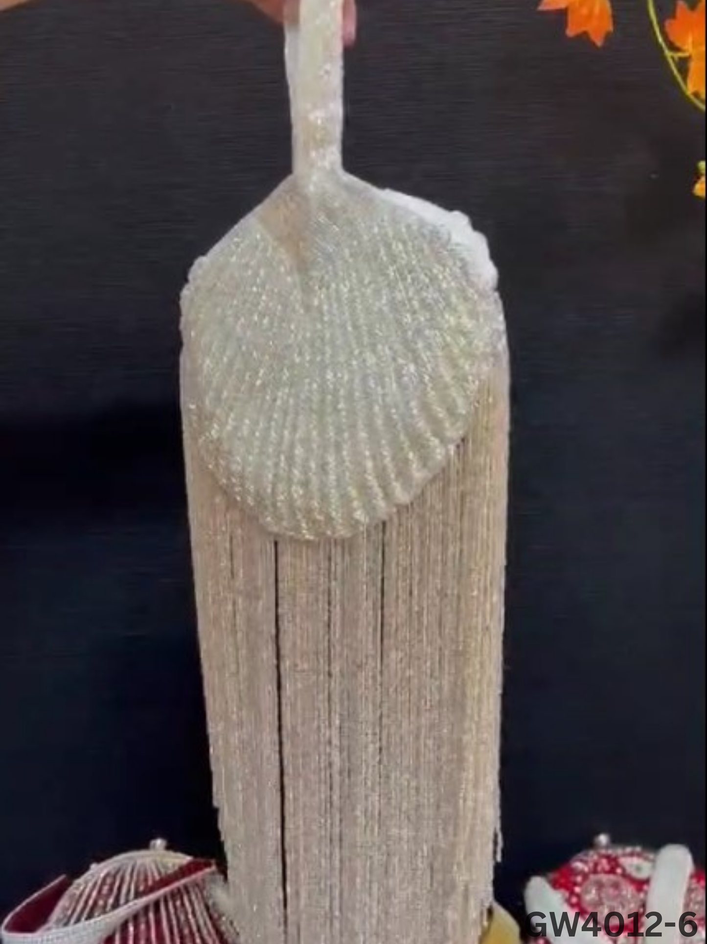 Gold Beaded Fringe Clutch with playful tassels and hidden button closure