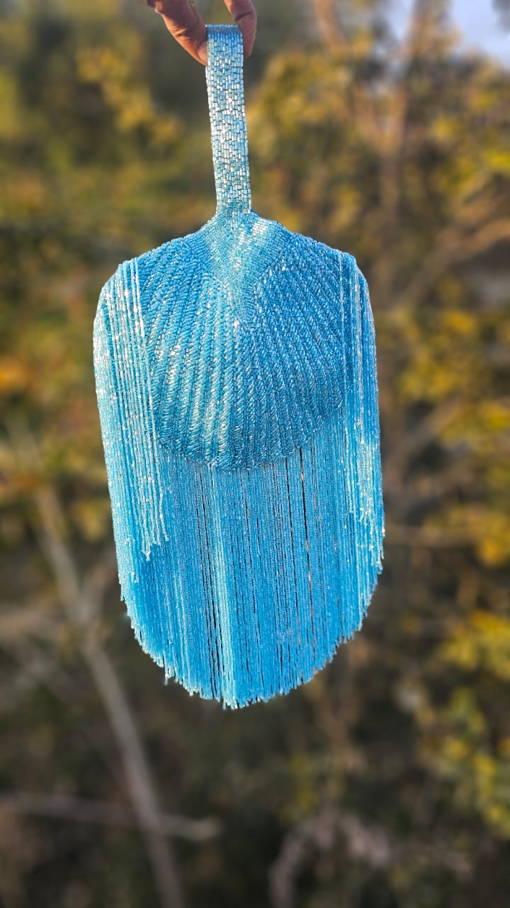 Gold Beaded Fringe Clutch with playful tassels and hidden button closure